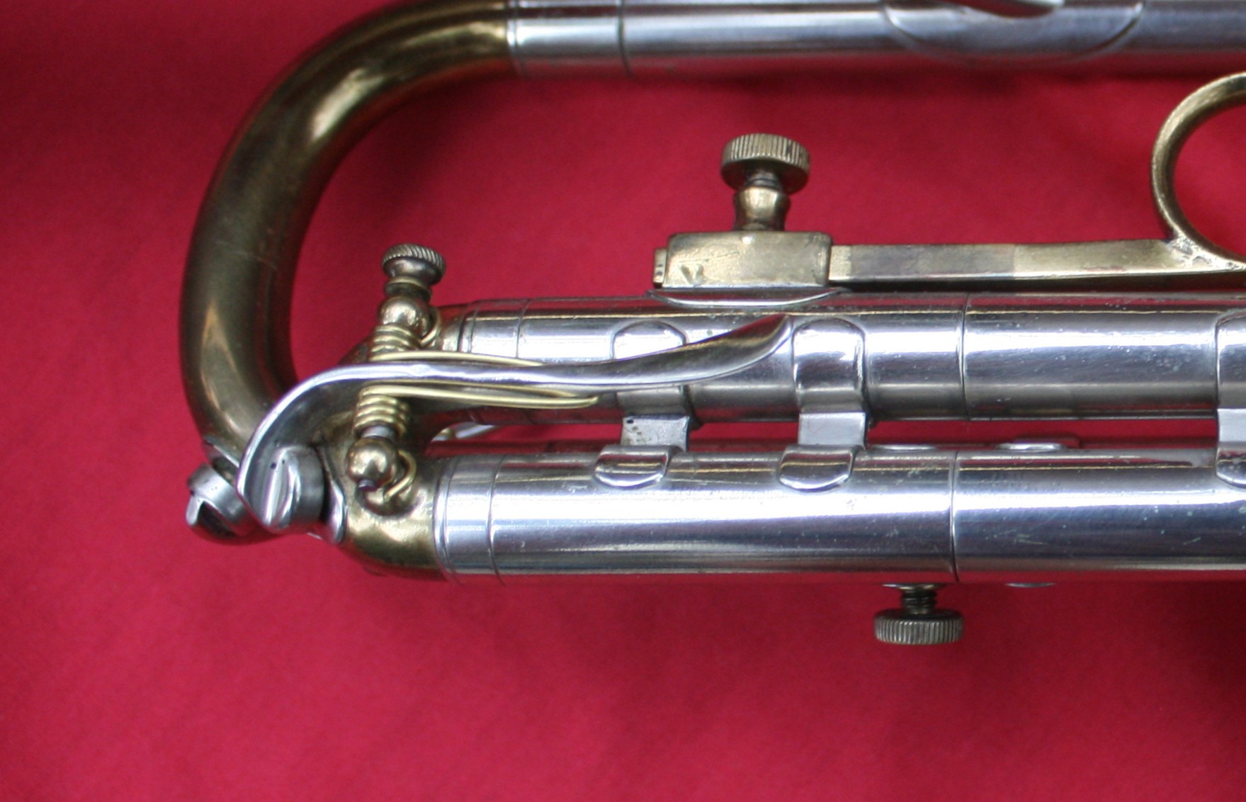 The lever is operated on the side of the slide (trombone style -1940's and older models)
